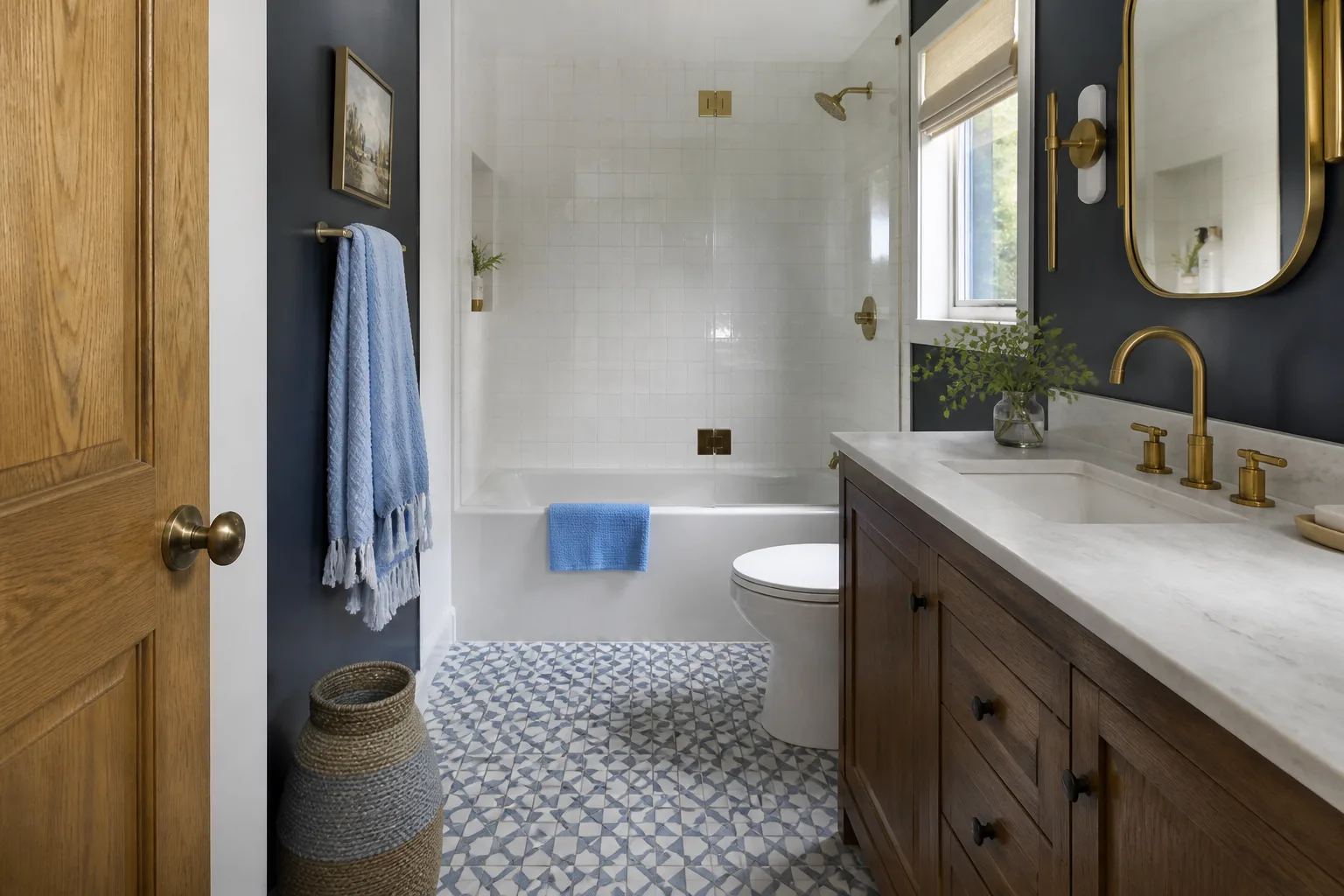 A remodeled hall bathroom with patterned floor tile and painted walls